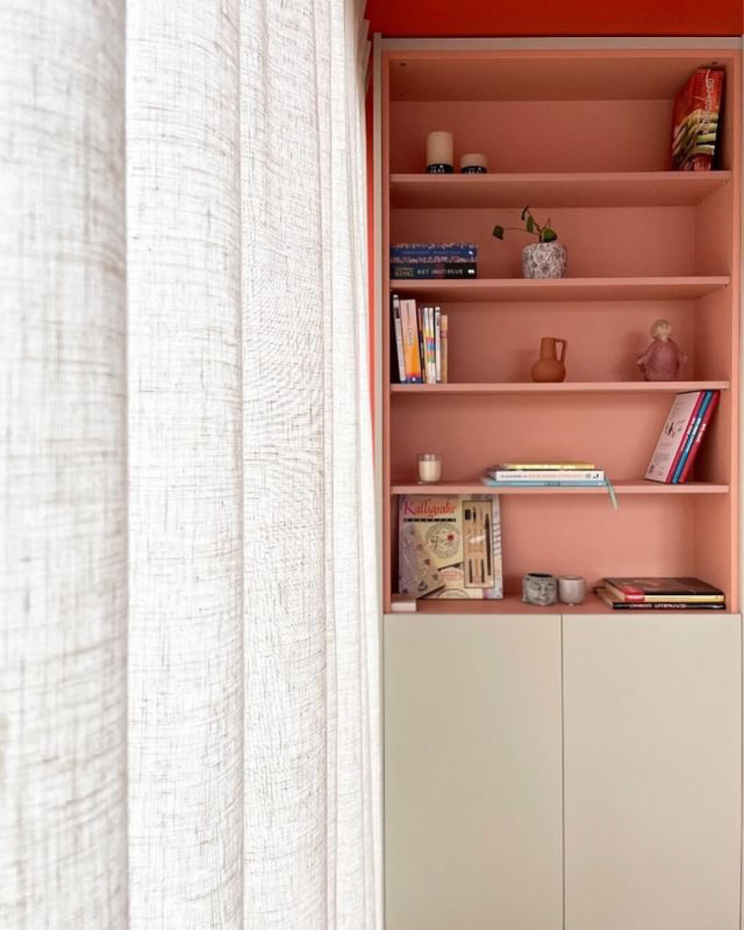 Custom living room cabinet in the colors Seashell and Dusty Coral.