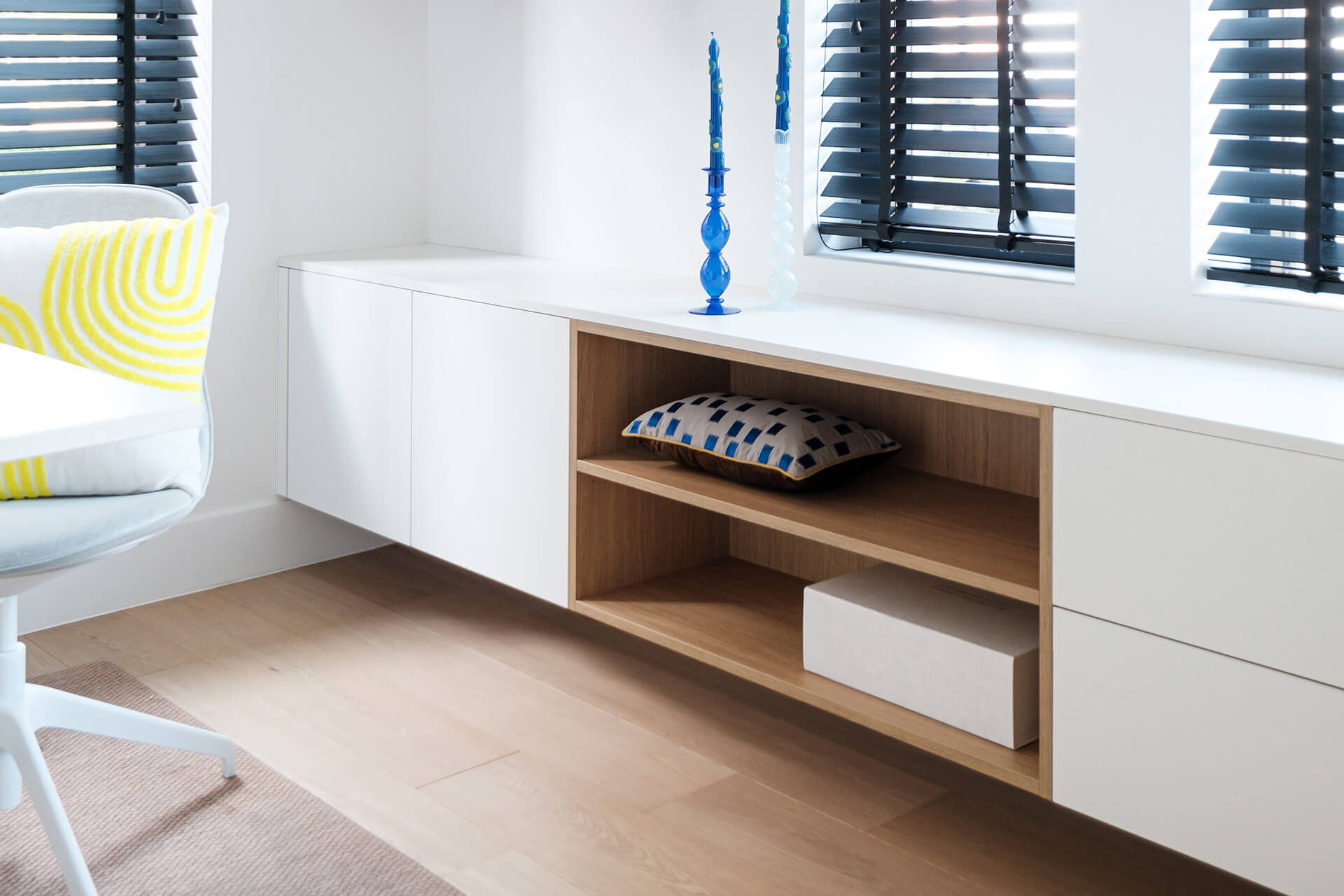 floating chest of drawers white with open compartment in wood structure in office area