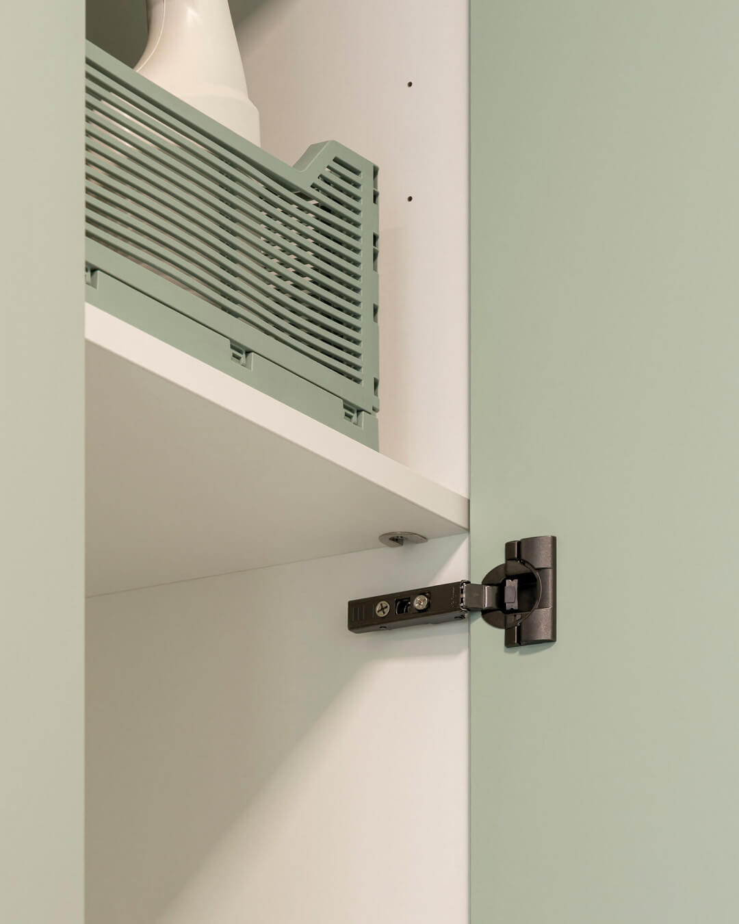 Black hinge in a bespoke storage cupboard