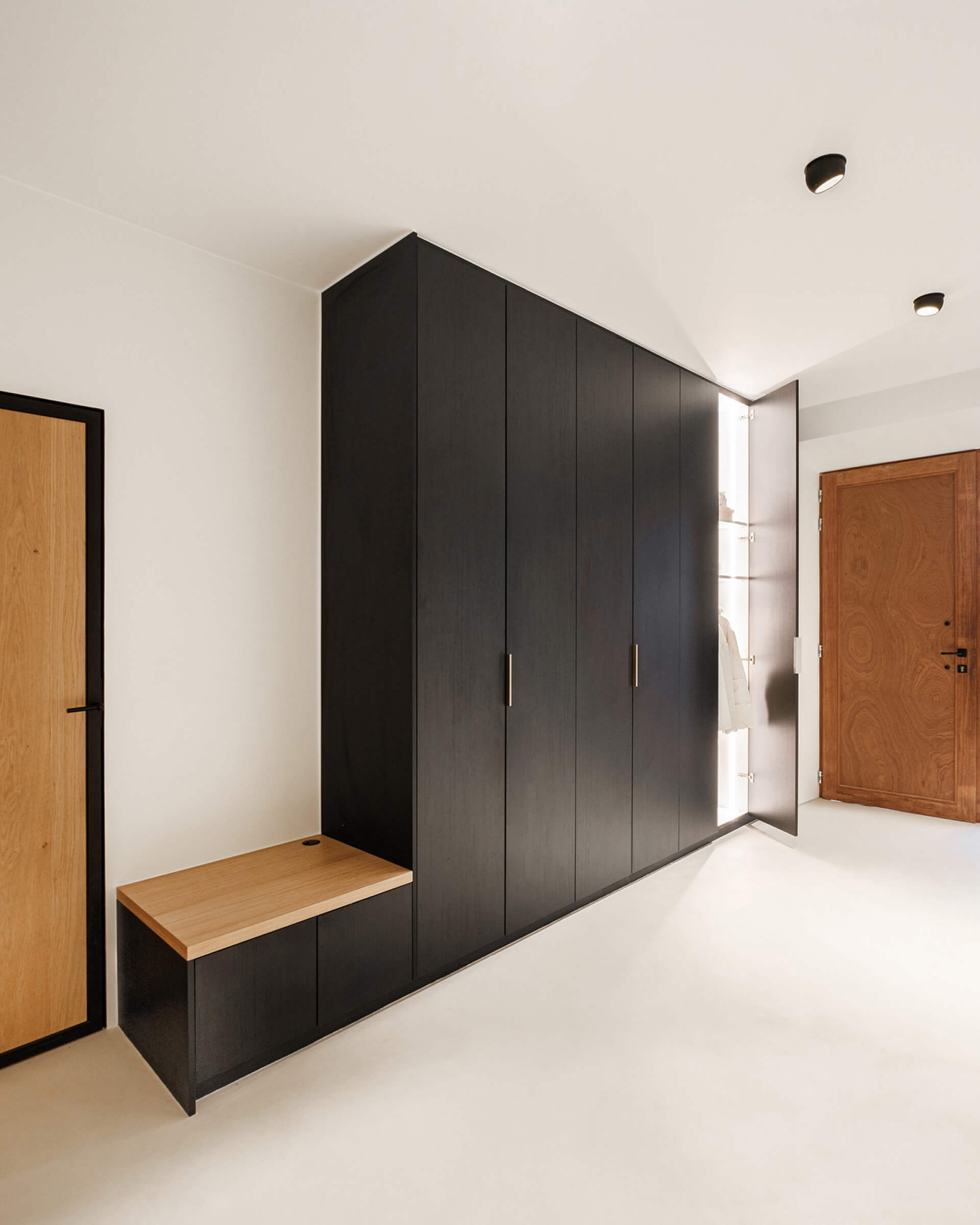 Custom cloakroom wardrobe with bench and LED lighting