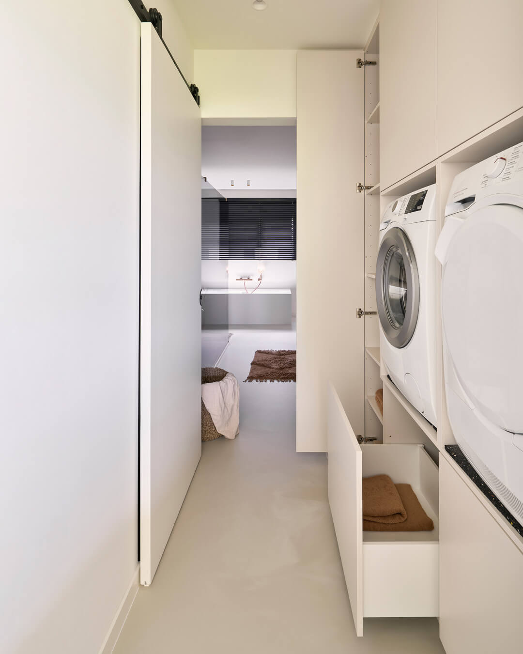 Custom laundry room with elevated washing appliances