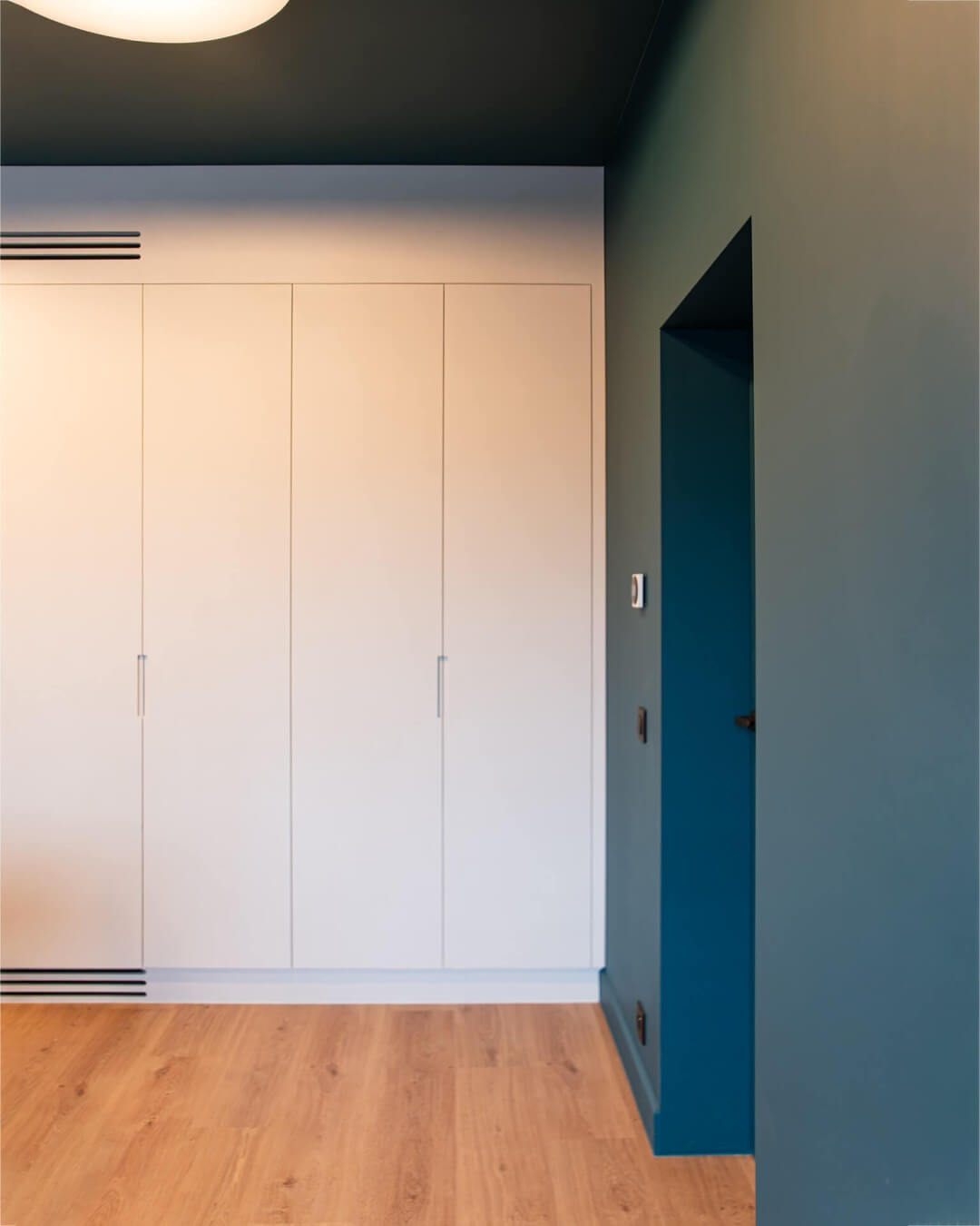 Bespoke storage cupboard with textured paint and recessed handles