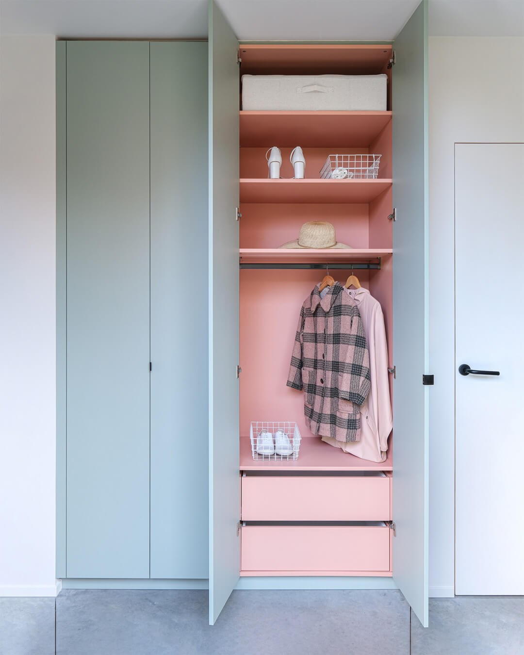 Custom hall closet in industrial green with a pink interior