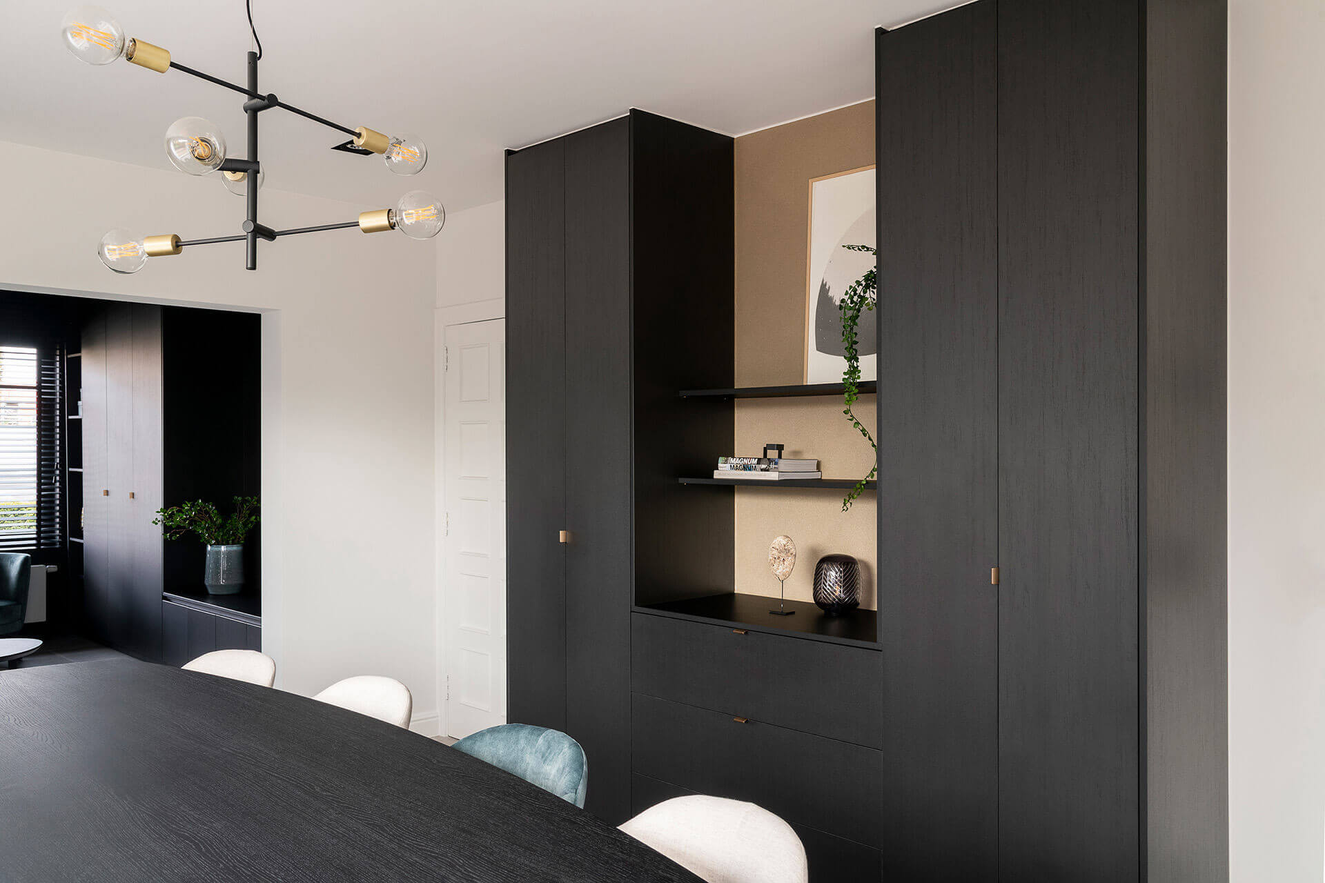 Wall unit combination, consisting of 2 tall storage cabinets and a chest of drawers in the middle