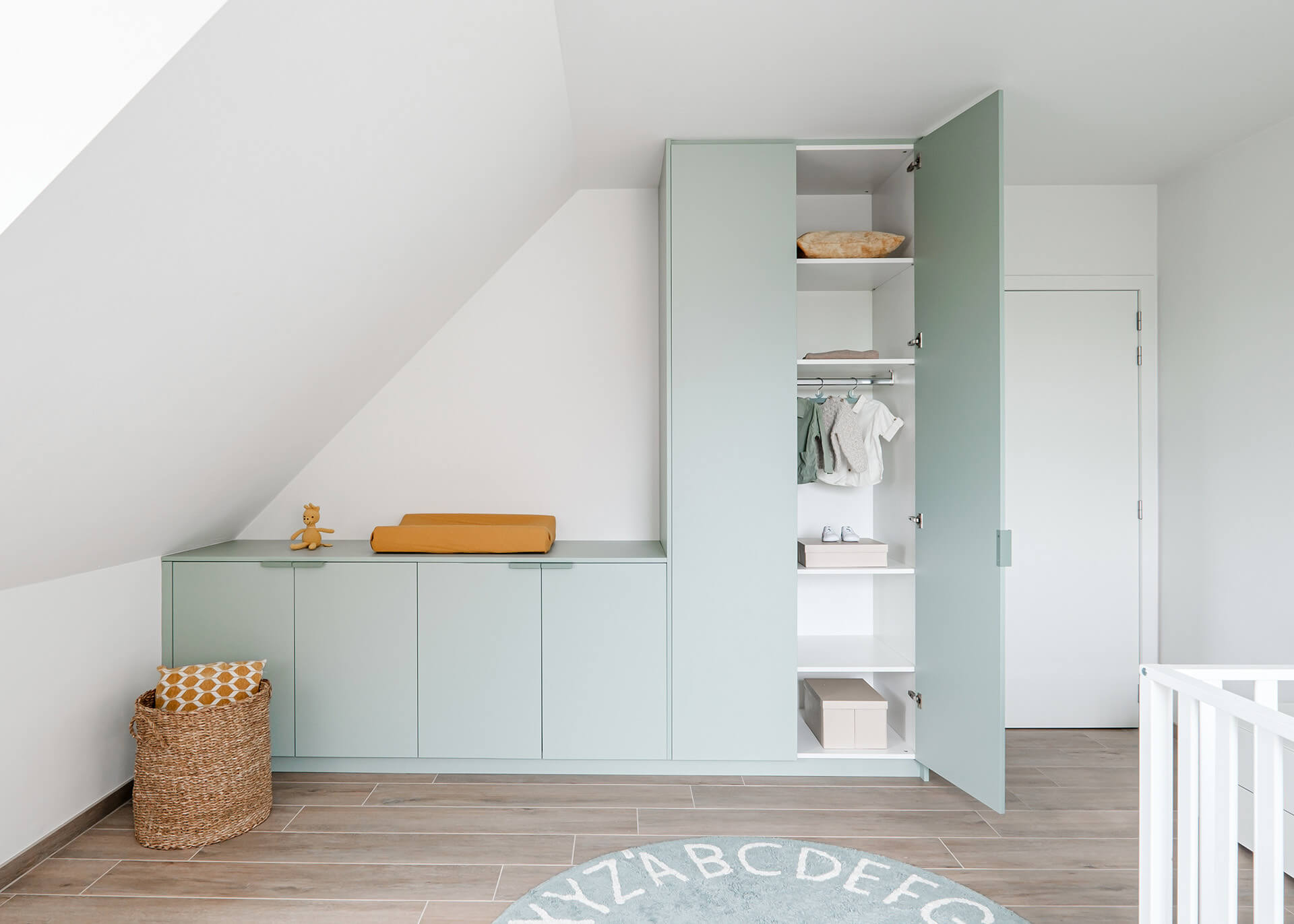 Custom wall combination cabinets in industrial green in a children's room