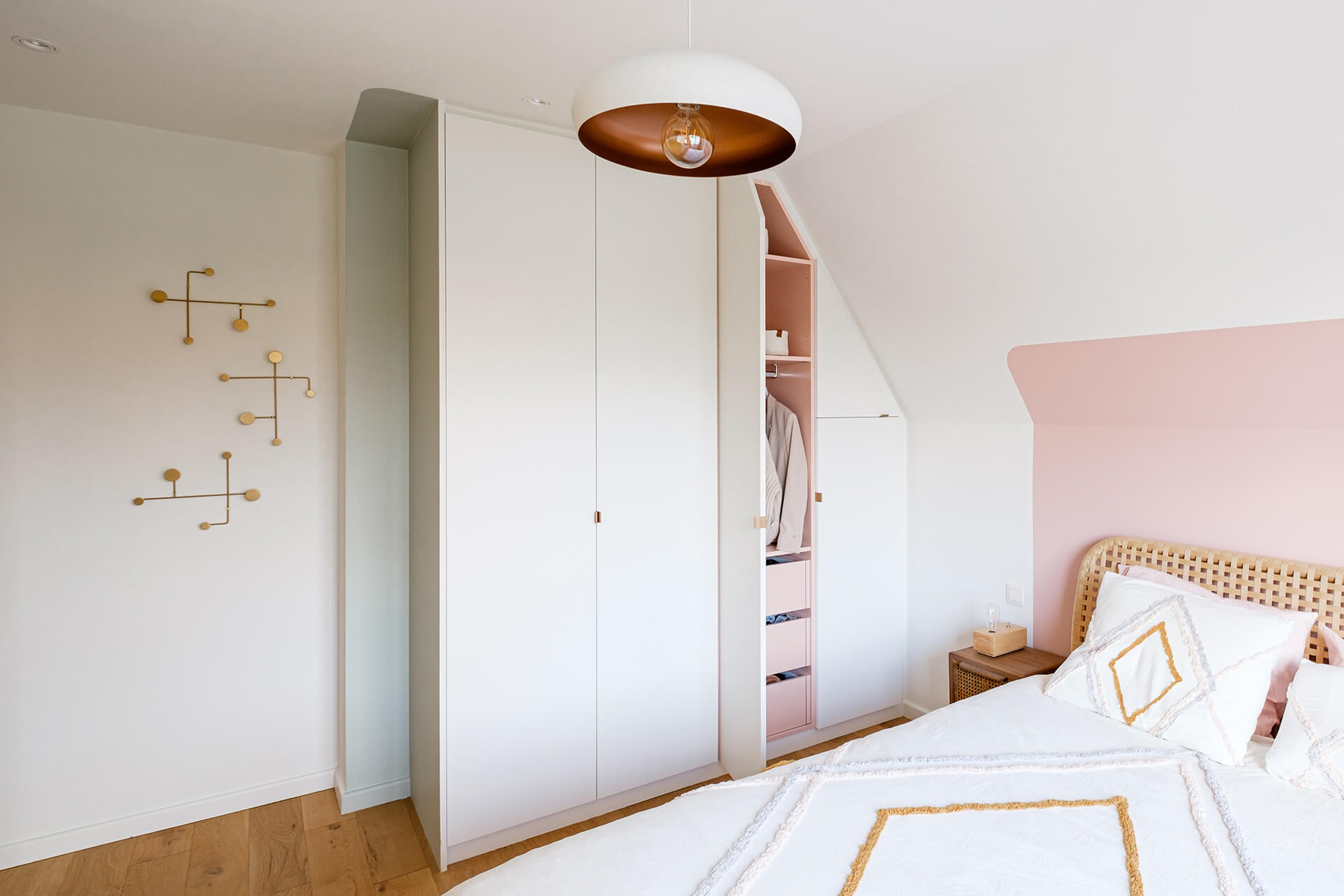 built in closet with subtle pink touch inside in girls bedroom