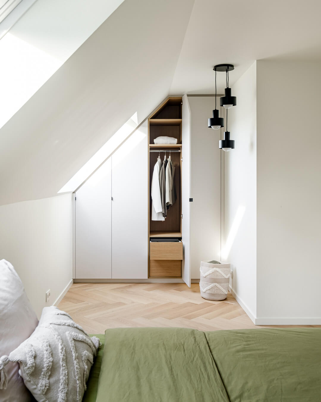 Custom cabinet under a sloping roof in Seashell with a wood texture interior.