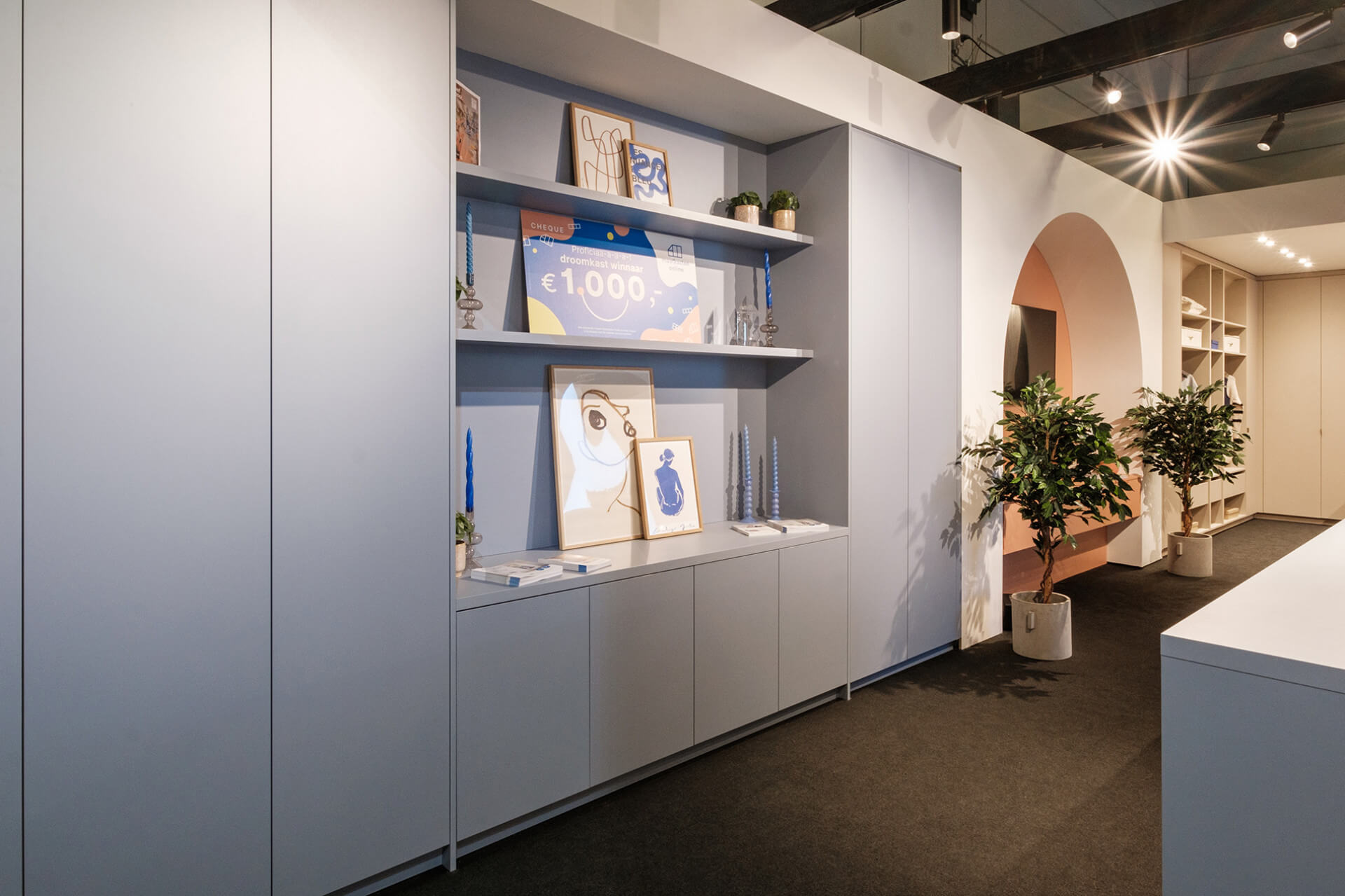 Wall combination furniture in the colour Silver Blue, presented at the BIS exhibition stand