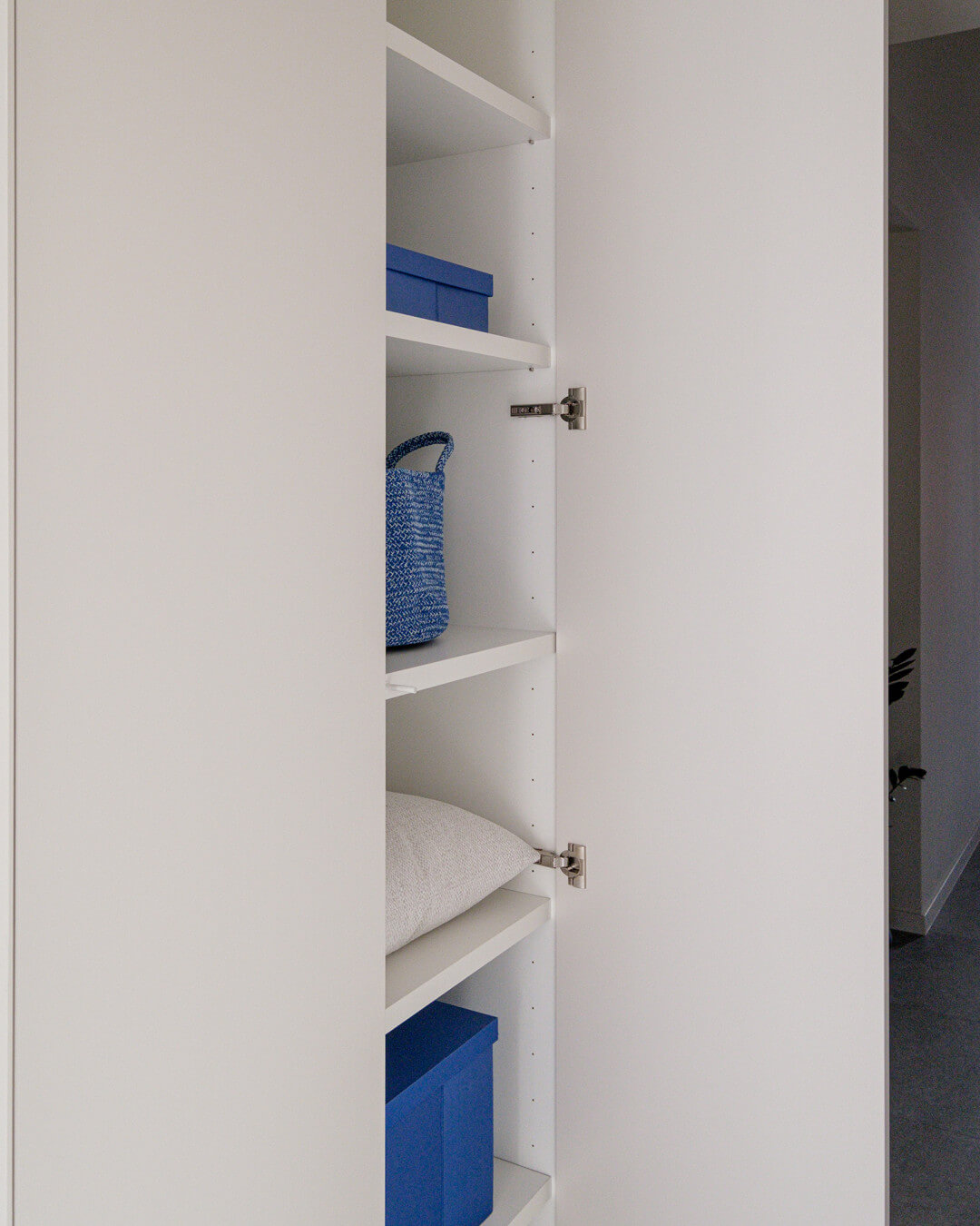 Détail des étagères extra-épaisses de l'armoire de rangement dans le hall d'entrée de la maison Sundae