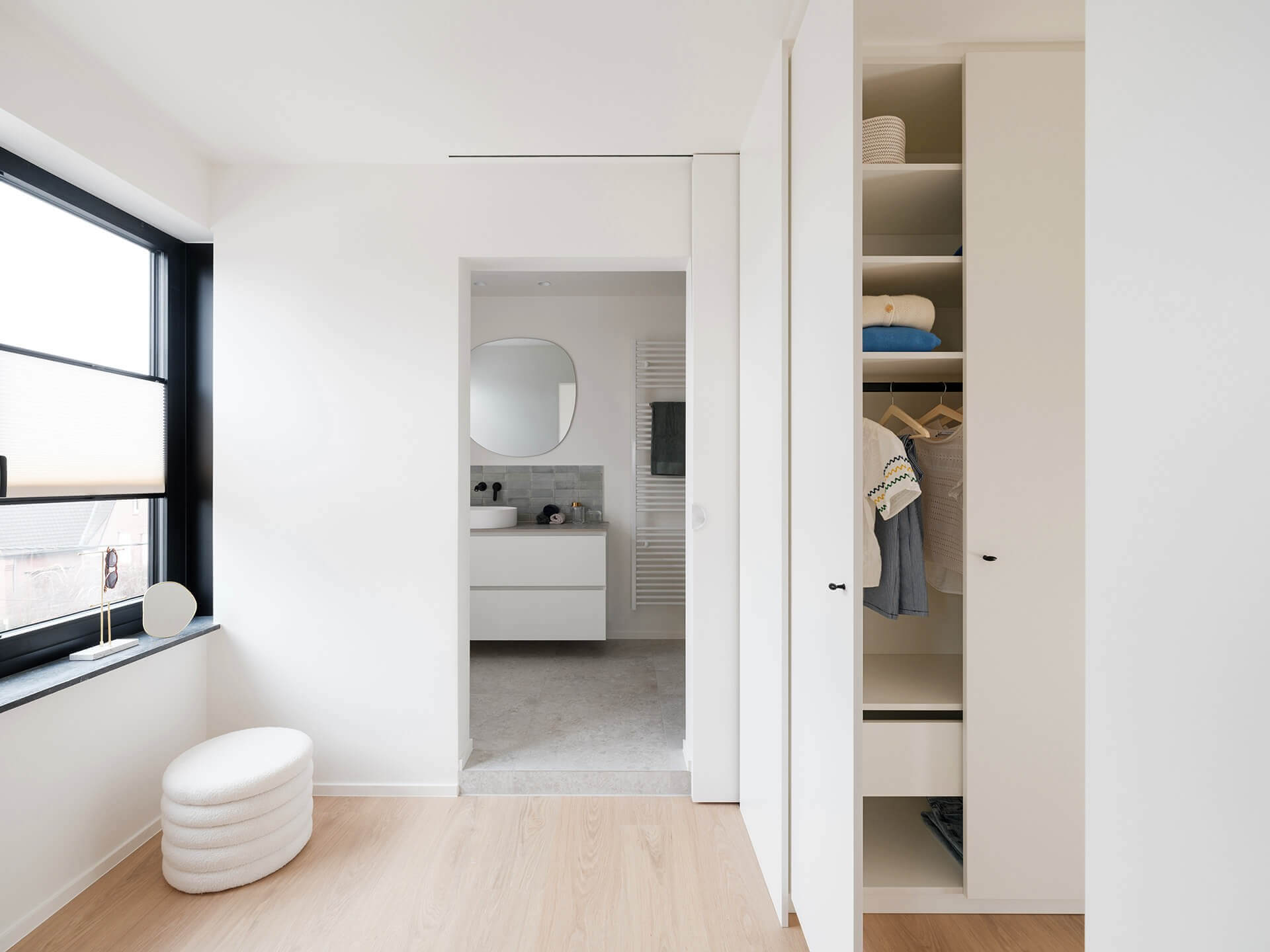 White bespoke walk-in wardrobes for bedroom at Sundae Huis