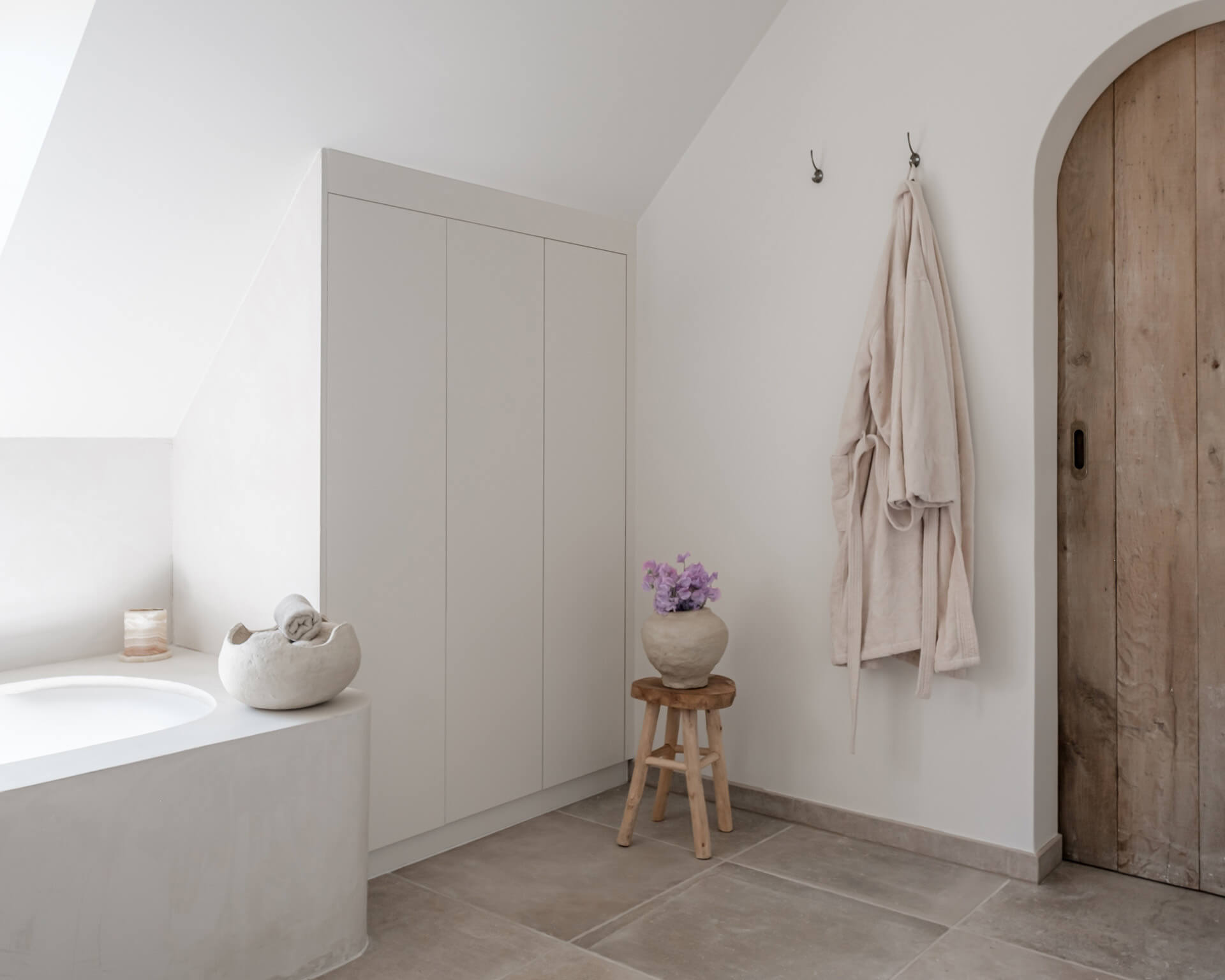 Cupboard with sloping back in bathroom finished in mdf 