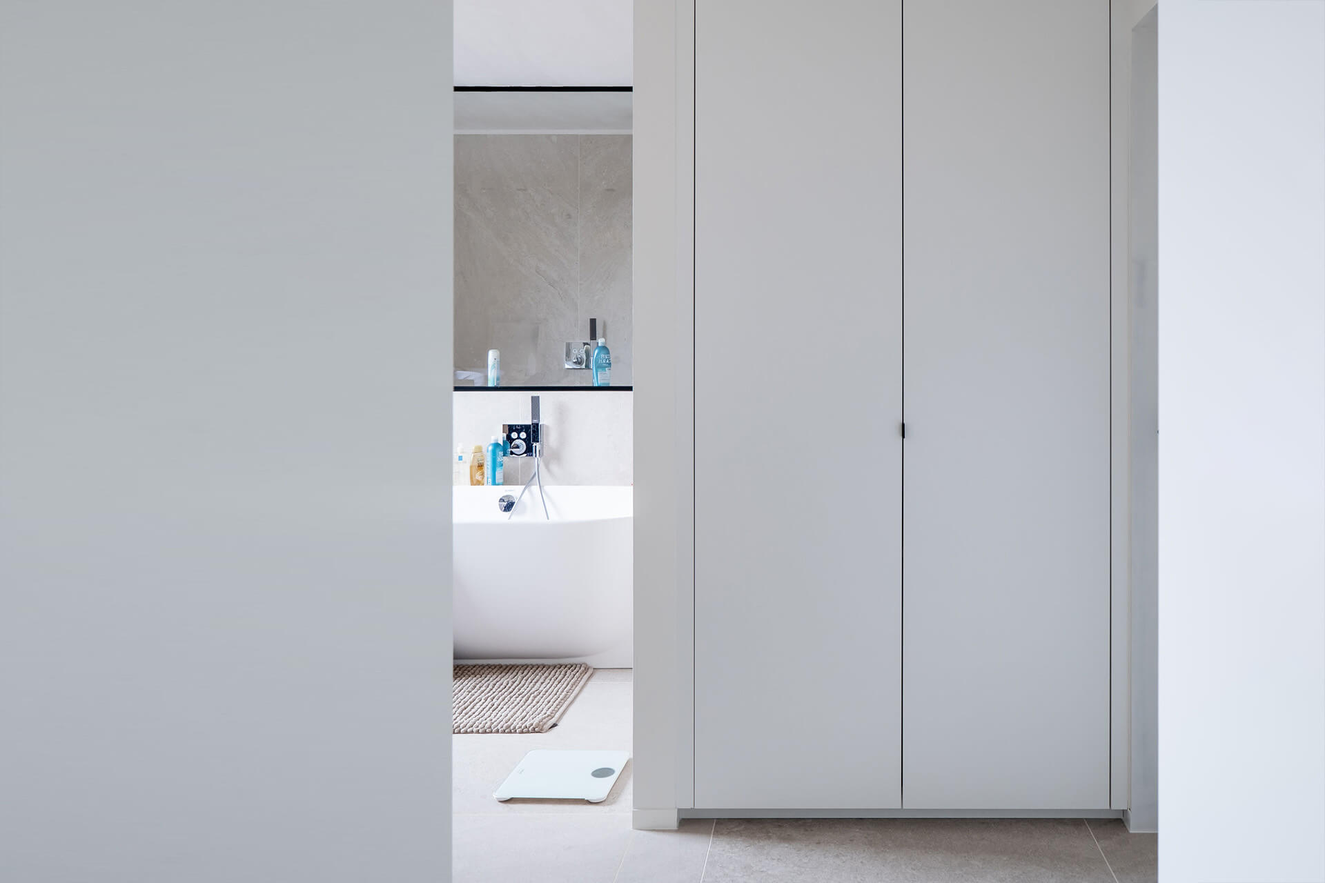 White custom-made storage unit in a bathroom