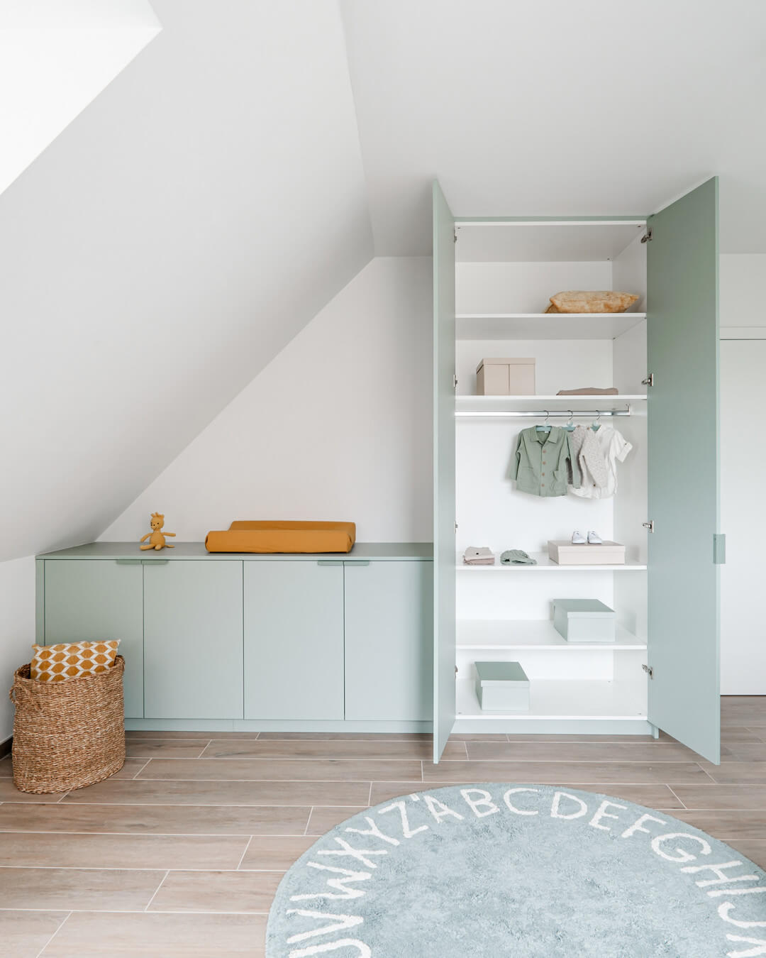 Custom wall cabinets in industrial green in a children's room