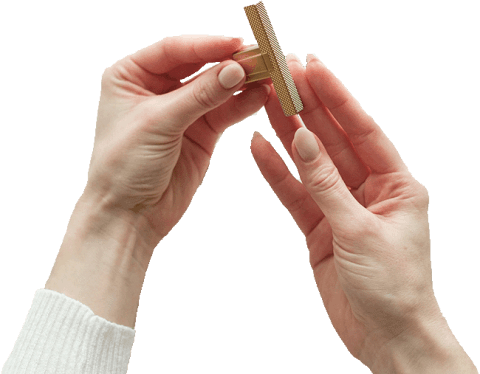 T-Diamond brass handle held by two hands.