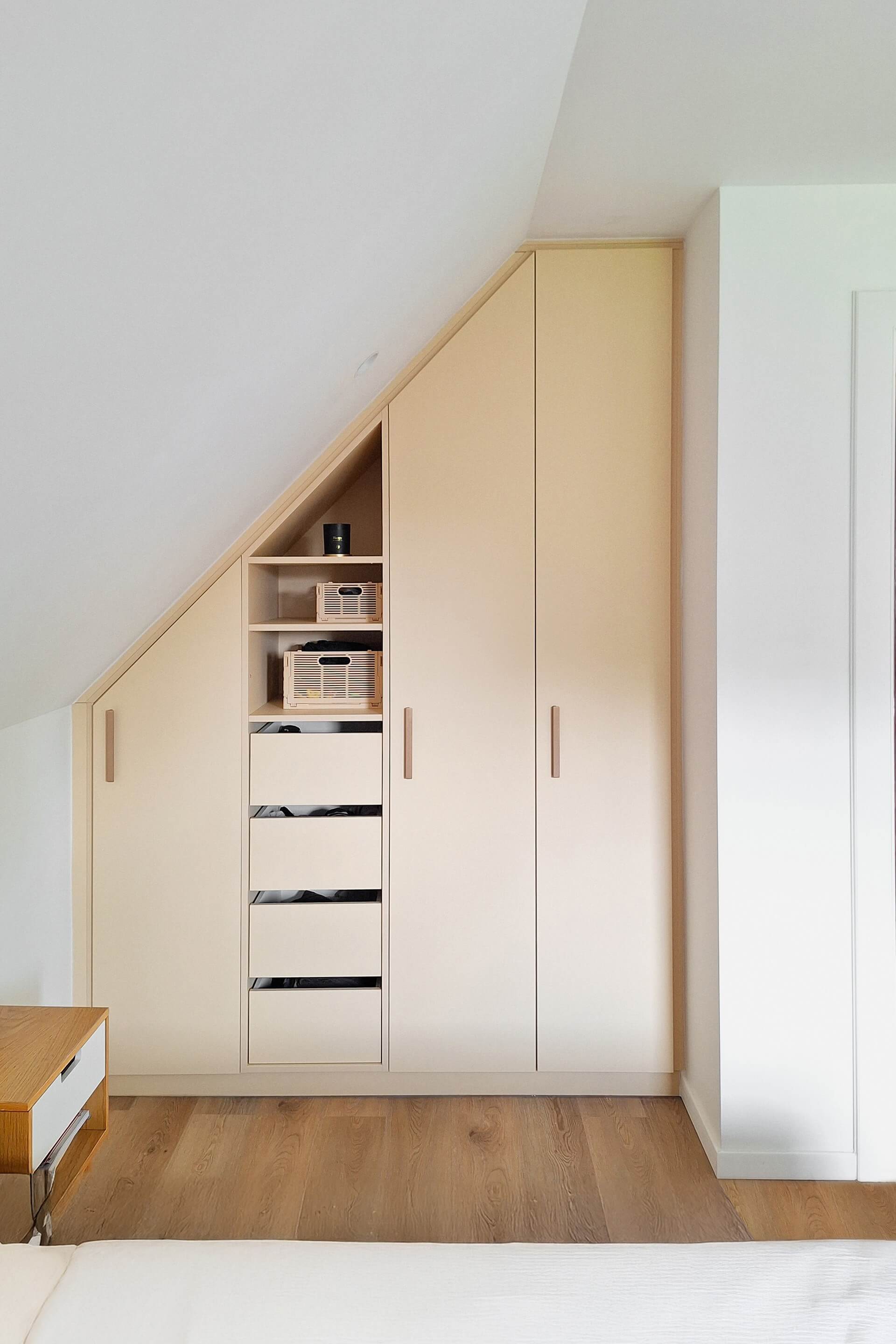 White custom-made slanted dressing cabinet with brass bar handles
